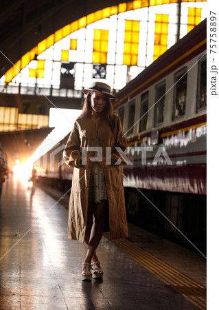 Young model travels on train at station railway in Summer 75758897