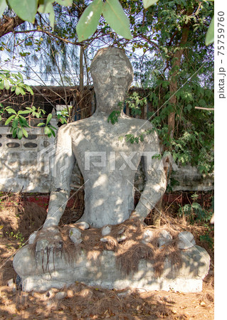 The reconstruction Buddha statue sitting under tropical tree. The reconstruction Buddha statue sitting under tropical tree. 75759760