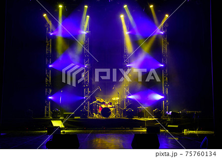 The light of searchlights in smoke on stage. 75760134