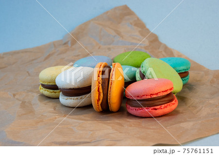 Multicolored macarons with wrapping craft paper. Multicolored macarons with wrapping craft paper. 75761151