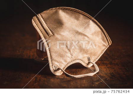 KN95 respirator mask for coronavirus protection. Brown face mask protects against covid-19 infection. 75762434