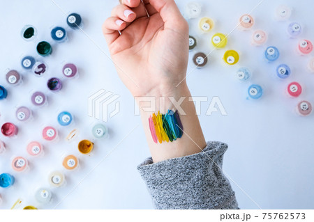 Rainbow LGBTQ flag painted on hand. Support for lgbt community. Honour of pride month. Connecting people, touching hands. 75762573