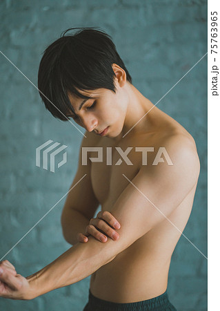 腕の筋肉を触る男性 腕の筋肉を触る男性 75763965