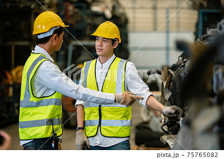 Teamwork engineers, Worker wear uniform and helmet talking in warehouse. 75765082