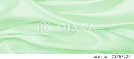 Smooth elegant green silk or satin luxury cloth texture as abstract background. Luxurious background design 75767226