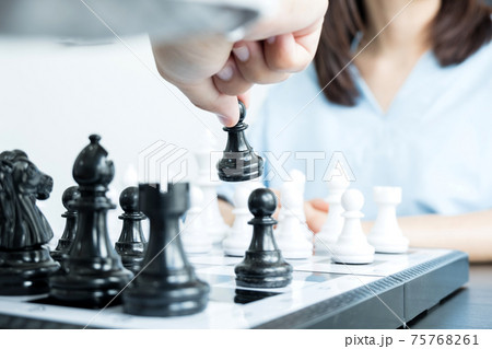 The hands of businessmen moving chess in chess competitions demonstrate leadership, followers, and strategic plans, business success building processes, and teamwork The hands of businessmen moving chess in chess competitions demonstrate leadership, followers, and strategic plans, business success building processes, and teamwork 75768261
