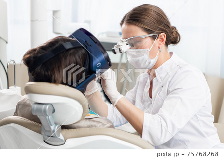 A close up picture of the process of modern dental treatment, wi A close up picture of the process of modern dental treatment, wi 75768268