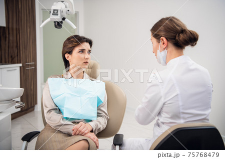A nice brunette woman having a dental check-up A nice brunette woman having a dental check-up 75768479