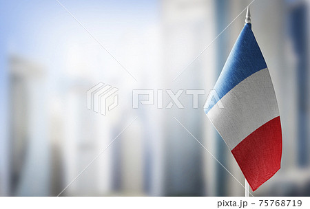 A small flag of France on the background of a blurred background A small flag of France on the background of a blurred background 75768719