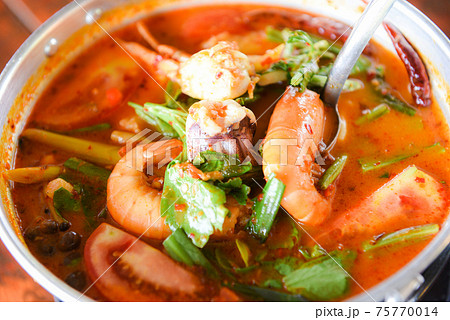 Prawn soup, Spicy soup with shrimp seafood coconut milk and chili pepper in pot, Hot and sour curry shrimps and squid Thai food Asian Prawn soup, Spicy soup with shrimp seafood coconut milk and chili pepper in pot, Hot and sour curry shrimps and squid Thai food Asian 75770014