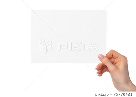 Woman's hand holding blank white sheet of paper isolated on white Woman's hand holding blank white sheet of paper isolated on white 75770431