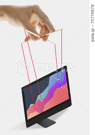Businessman keeping the growth in economy, manipulating graphs like puppet Businessman keeping the growth in economy, manipulating graphs like puppet 75770679