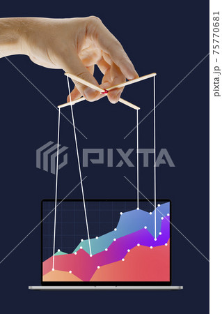 Businessman keeping the growth in economy, manipulating graphs like puppet 75770681