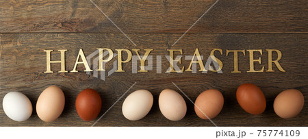 Natural colored gradient Easter eggs line on wooden background. Minimal Easter concept. 75774109