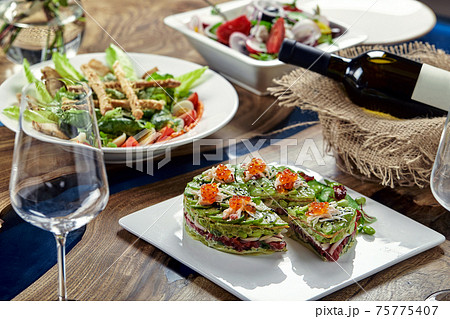 Beautifully decorated catering banquet table with different food snacks and appetizers 75775407