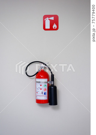 Fire extinguisher and fire department sign on a white wall. Fire extinguisher and fire department sign on a white wall. 75779400