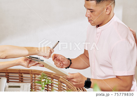 Hotel guest filling questionnaire 75779830