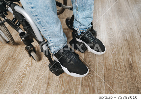 Unrecognizable disabled man sitting in a wheelchair Unrecognizable disabled man sitting in a wheelchair 75783010