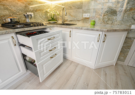 Drawers pulled out at modern classic white kitchen furniture Drawers pulled out at modern classic white kitchen furniture 75783011
