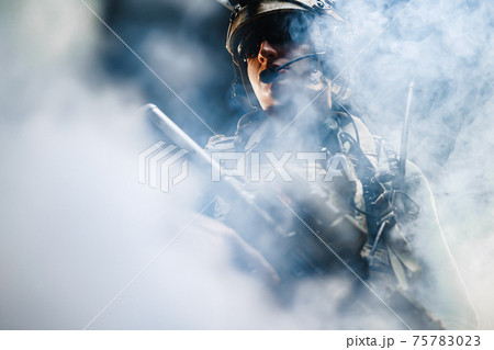 Portrait of speacial froces soldier standing in smoke in the dark Portrait of speacial froces soldier standing in smoke in the dark 75783023