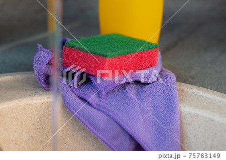 Cleaning sponge and rag on kitchen counter 75783149