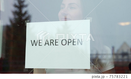 Woman stickers We are open re-opens after the end of the coronavirus quarantine in the cafe the coffee shop is ready for service 75783221