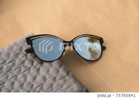 Cat Eye Sunglasses model for women with a very special design shoot outside in a summer day . Selective focus Cat Eye Sunglasses model for women with a very special design shoot outside in a summer day . Selective focus 75783841