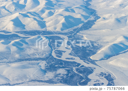 Aerial view of a river in a mountain valley Aerial view of a river in a mountain valley 75787066