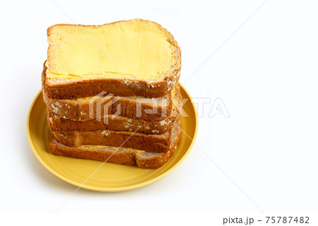 Bread slices with butter on white 75787482