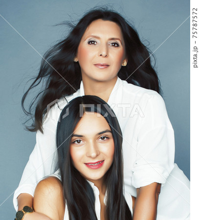 cute pretty teen daughter with mature mother hugging, fashion style brunette, lifestyle people concept 75787572