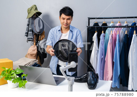 man selling hat and clothes online by smartphone live streaming, business online e-commerce at home man selling hat and clothes online by smartphone live streaming, business online e-commerce at home 75788980