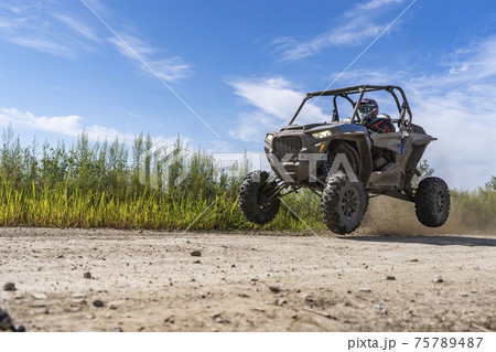 ATV adventure. Buggy extreme ride on dirt track. UTV ATV adventure. Buggy extreme ride on dirt track. UTV 75789487