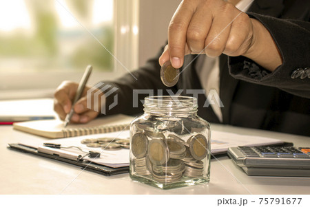 Businessmen are saving money or income from investing, ideas of investment budgets, and saving money in the economic downturn. 75791677