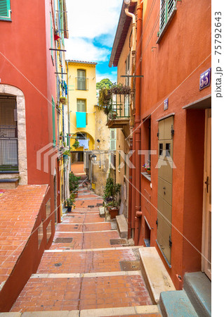 Old narrow street in Menton, France Old narrow street in Menton, France 75792643