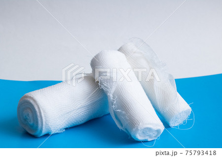 White bandage on a blue background closeup White bandage on a blue background closeup 75793418