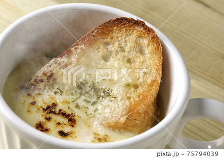 チーズに焦げ目のついてるフランスパンが入った熱々オニオンスープ チーズに焦げ目のついてるフランスパンが入った熱々オニオンスープ 75794039