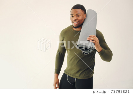 Handsome black man doing yoga on a white background Handsome black man doing yoga on a white background 75795821
