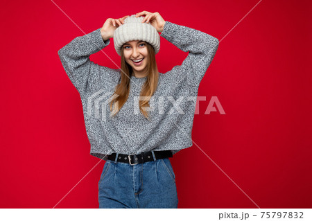 Beautiful positive happy young dark blonde woman isolated over colourful background wall wearing 75797832