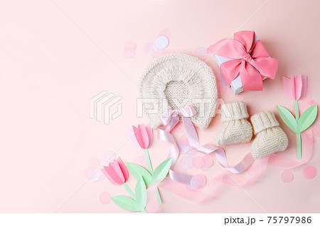 Beautiful composition with baby booties shoes, bonnet and gift box on pink background. Concept of baby shower party, pregnancy, mother day, first birthday holiday card, copy space, banner 75797986