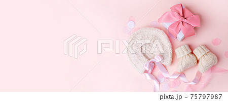 Beautiful composition with baby booties shoes, bonnet and gift box on pink background. Concept of baby shower party, pregnancy, mother day, first birthday holiday card, copy space, banner 75797987