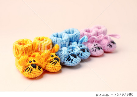 Baby shower, gender party. Boy, girl, queer, neatral. Three pairs of baby socks, booties with funny bunny decor, celebration concept when the gender of the child becomes known 75797990
