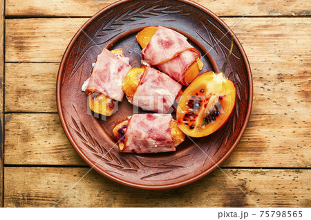 Baked ham with tamarillo on plate Baked ham with tamarillo on plate 75798565