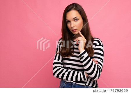 Shot of thoughtful beautiful young woman deep thinking creative female person holding arm on chin 75798669