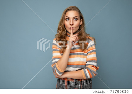 Shot of young blonde wavy-haired woman with sincere emotions wearing striped sweater isolated on 75799336