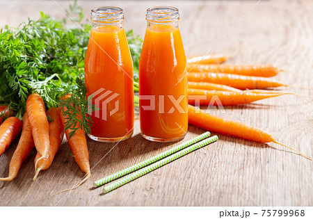bottles of fresh carrot juice bottles of fresh carrot juice 75799968