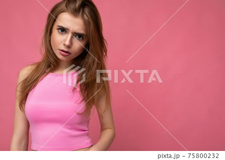 Sad upset young beautiful dark blond woman isolated on background with copy space wearing stylish 75800232