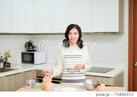 cooking and home concept - close up of female hands kneading dough at home cooking and home concept - close up of female hands kneading dough at home 75800353
