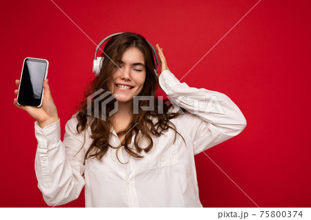 Attractive positive smiling young woman wearing stylish casual outfit isolated on colourful Attractive positive smiling young woman wearing stylish casual outfit isolated on colourful 75800374