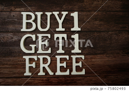 Buy 1 Get 1 Free with space copy on wooden background Buy 1 Get 1 Free with space copy on wooden background 75802493