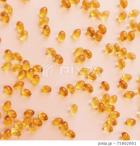 Omega three capsules on beige background flat lay. Health concept. Vitamin pills 75802601